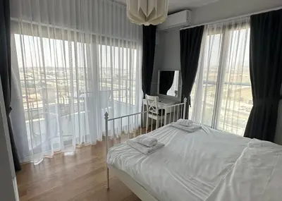 a bedroom with a bed and a large window at One-Bedroom Apartment in Caesar Blue Complex in Protaras