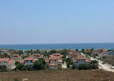 a group of houses on a hill next to the ocean at One-Bedroom Apartment in Caesar Blue Complex in Protaras