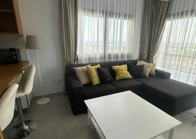 a living room with a couch and a table at One-Bedroom Apartment in Caesar Blue Complex in Protaras