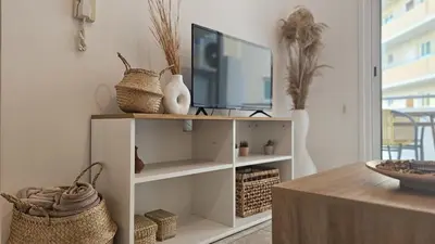 a living room with a tv on a shelf at STAY Miracle Apartment in Larnaka