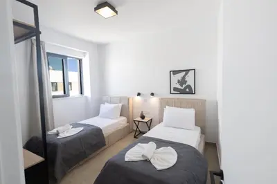 a room with two beds and a window at Ayia Napa Orea Villa OR2 in Ayia Napa