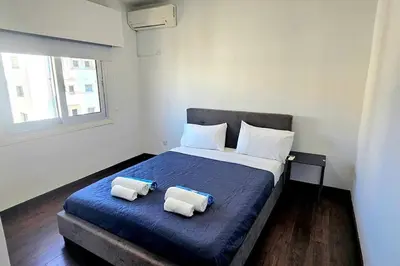 a bedroom with a bed with two pillows on it at Central Park Suave 2 Bed in Limassol