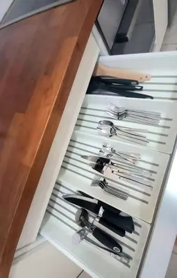 a drawer filled with silver utensils in a kitchen at Central Park Suave 2 Bed in Limassol