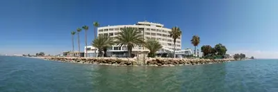 a building on an island in the middle of the water at GARNET Beach Apartment in Voroklini