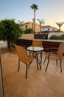 a patio with two chairs and a table on a patio at Sunflight Apt 01B One Bedroom Apt in Larnaka