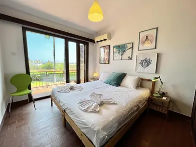 a bedroom with a bed and a large window at STAY Perla House in Protaras