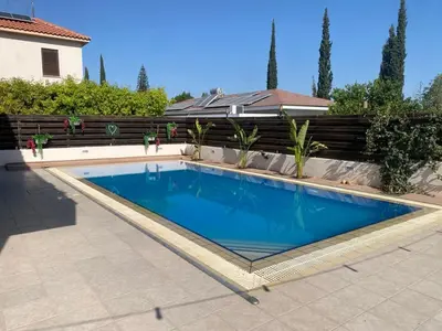 a swimming pool in a backyard with a fence at Dali Villa in Dhali
