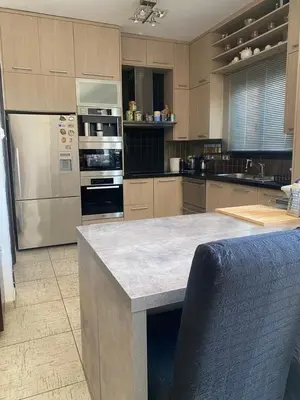 a kitchen with stainless steel appliances and a counter at Dali Villa in Dhali