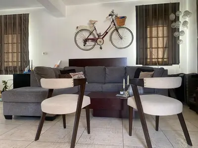 a living room with a couch and a bike on the wall at Dali Villa in Dhali