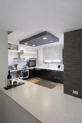 a large white kitchen with a large counter top at Blue Tulip - Strovolos in Kato Lakatamia