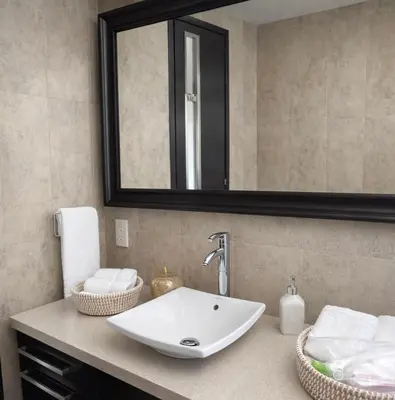 a bathroom with a sink and a mirror at Blue Tulip - Strovolos in Kato Lakatamia