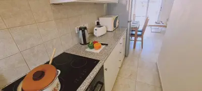 a kitchen with a stove and a counter top at STAY Sunshine Apartment in Protaras