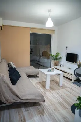 a living room with a couch and a table at ONAR mackenzie 1 in Larnaka