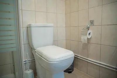 a bathroom with a toilet and a roll of toilet paper at ONAR mackenzie 1 in Larnaka