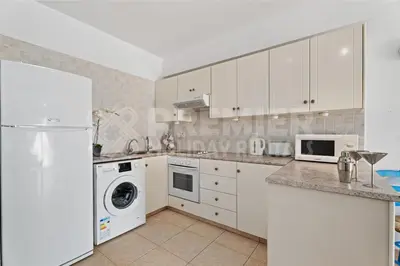 a kitchen with white appliances and a white refrigerator at Apartment Karlota in Paralimni