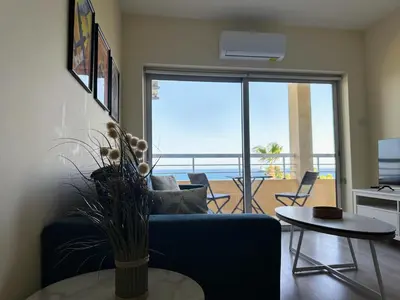 a living room with a couch and a table at Seaview Apartment in Limassol in Limassol