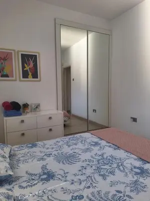 a bedroom with a bed and a large mirror at Oceanside Living - Modern 1 bedroom in Limassol