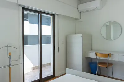 a room with a table and a chair and a refrigerator at Cosy & Bright European Uni Apt in Strovolos