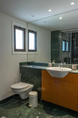 a bathroom with a toilet and a sink at Cosy & Bright European Uni Apt in Strovolos