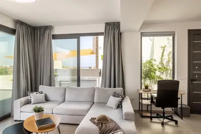a living room with a couch and a table at Seaside Emerald in Paralimni