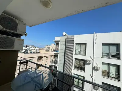 a balcony with a view of a building at Girne Merkez Daire in Aglantzia
