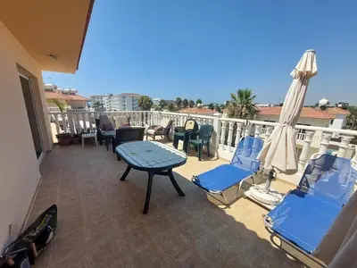 a balcony with chairs and a table on a balcony at 1BR Apt, Huge Balcony, Walk to Nissi Beach in Ayia Napa
