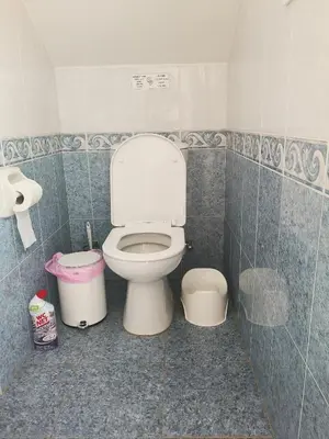 a bathroom with a toilet and two trash cans at Efterpis12 St. House in Paralimni