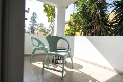 two green chairs sitting on a porch at 2 bedroom flat in city centre in Nicosia