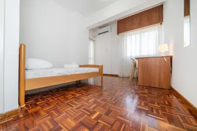 a bedroom with a bed and a wooden floor at Cozy 3 bedroom flat city center in Nicosia