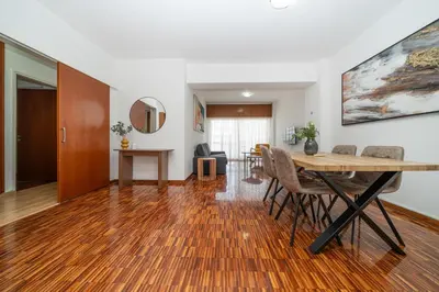 a dining room and living room with a table and chairs at Cozy 3 bedroom flat city center in Nicosia