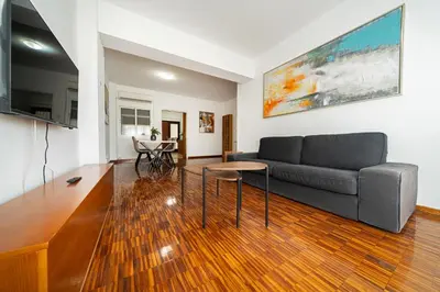 a living room with a couch and a table at Cozy 3 bedroom flat city center in Nicosia