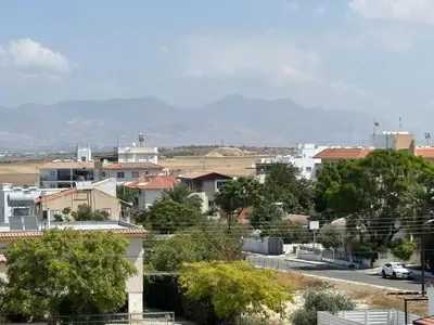 a view of a city with mountains in the background at Michaela's place in Aglantzia