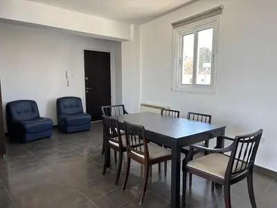 a dining room with a table and chairs at Michaela's place in Aglantzia