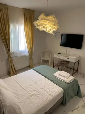 a bedroom with a bed and a desk and a television at Modern house in Larnaca in Larnaka
