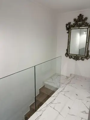 a mirror on a wall next to a stair case at Modern house in Larnaca in Larnaka
