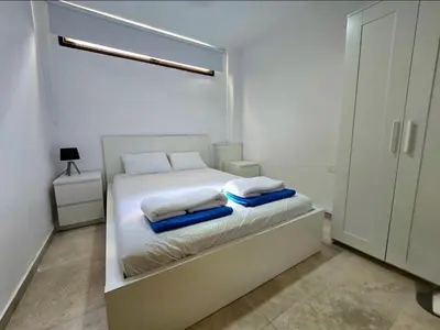a white bedroom with a bed with towels on it at Larnaca Villa in Sophtadhes
