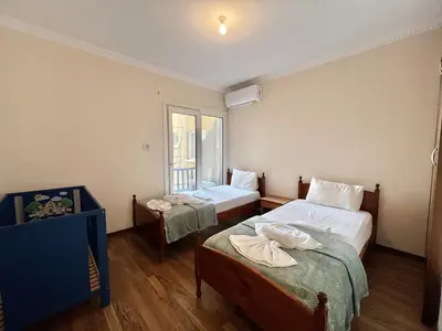 a small room with two beds and a window at STAY Napa Oniro Apartment in Ayia Napa