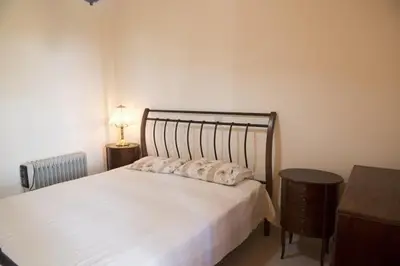 a bedroom with a bed with two pillows on it at Marianna Mansion in Pachna
