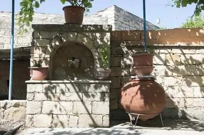 two large vases sitting next to a brick wall at Marianna Mansion in Pachna