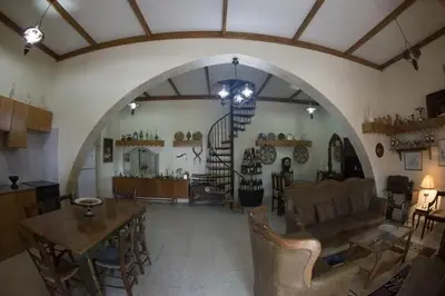 a living room with a couch and a table at Marianna Mansion in Pachna