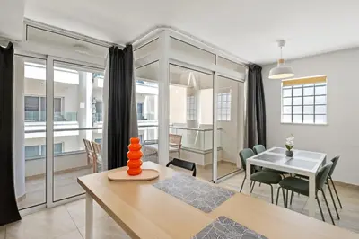 a dining room and living room with a table at Giorgio Downtown 2 Bedroom Apartment in Larnaka