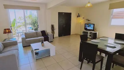 a living room with a couch and a dining room at STAY Sunny Bay Villa in Protaras