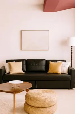 a black couch in a living room with a coffee table at Larnaca Seaview Apartment with pool & parking in Larnaka