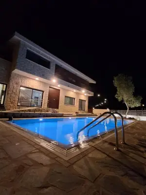 a swimming pool in front of a house at night at Melissa Hills in Ayia Napa