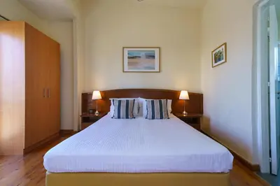 a bedroom with a large white bed with two lamps at Central Penthouse Sky Suite in Nicosia