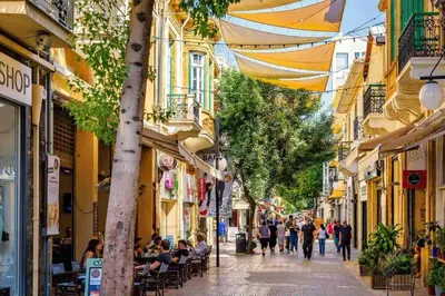 a group of people walking down a street with buildings at City Centre Studio Eleftheria Sq in Nicosia
