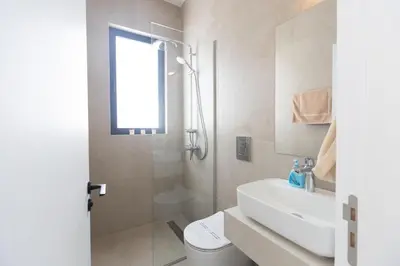a bathroom with a toilet and a sink and a shower at Ayia Napa Orea Villa OR8 in Ayia Napa