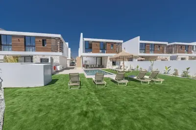 a yard with chairs and a swimming pool in a house at Ayia Napa Orea Villa OR8 in Ayia Napa