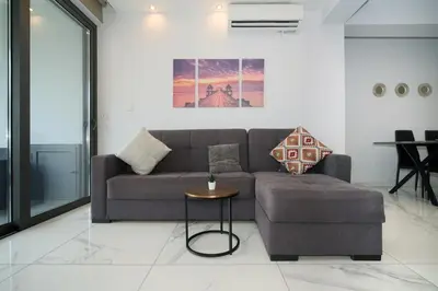 a living room with a couch and a table at Luxury Modern Larnaca Central in Larnaka