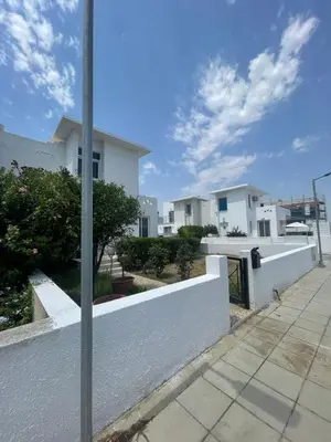 a white fence in front of a house at Azure Waves House in Voroklini